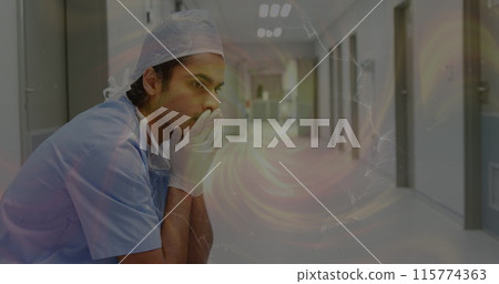 Image of moving spiral over sad biracial male nurse in hospital Image of moving spiral over sad biracial male nurse in hospital 115774363