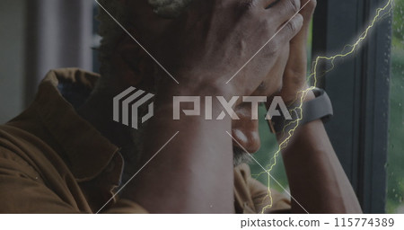 Image of lightning over sad senior african american man 115774389