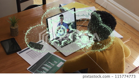 Image of setting over a cloud icon over african american woman having a image call on laptop Image of setting over a cloud icon over african american woman having a image call on laptop 115774773