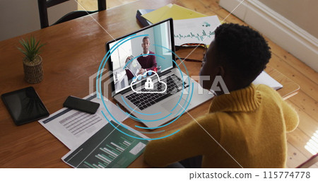 Image of security padlock over cloud over african american woman having a image call on laptop Image of security padlock over cloud over african american woman having a image call on laptop 115774778
