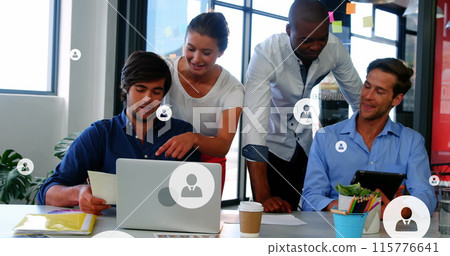 Image of profile icons over diverse coworkers discussing reports on laptop and digital tablet 115776641