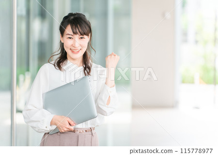 Business woman/working mom with laptop in front of a building (fist pump/career advancement/job change) 115778977
