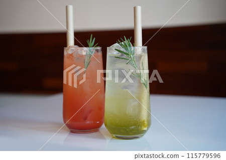 Refreshing summer cocktails with ice and rosemary on the table 115779596