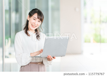 A businesswoman with a laptop in front of a building (real estate appraiser, labor consultant, tax accountant, accountant, female professional) 115779767