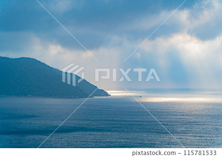The rays of the sun through the clouds over the sea. The rays of the sun through the clouds over the sea. 115781533