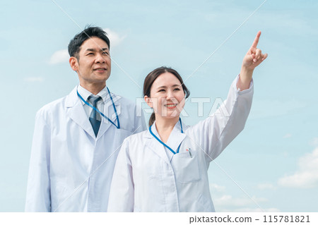 Doctors, physicians, medical staff in white coats working in a hospital under the blue sky 115781821