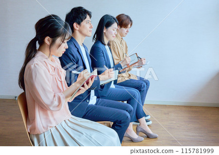 Business people taking notes in a conference room 115781999
