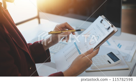 .Cropped image of professional businesswoman working at her office via laptop, young female manager using portable computer device while sitting at modern loft, flare light, work process concept 115782598