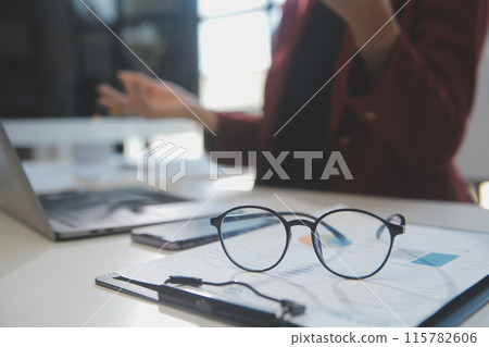 .Cropped image of professional businesswoman working at her office via laptop, young female manager using portable computer device while sitting at modern loft, flare light, work process concept .Cropped image of professional businesswoman working at her office via laptop, young female manager using portable computer device while sitting at modern loft, flare light, work process concept 115782606
