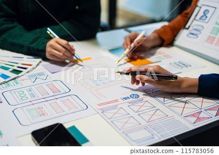 UX developer and ui designer brainstorming about mobile app interface wireframe design with customer breif and color code, User experience concept.. UX developer and ui designer brainstorming about mobile app interface wireframe design with customer breif and color code, User experience concept.. 115783056