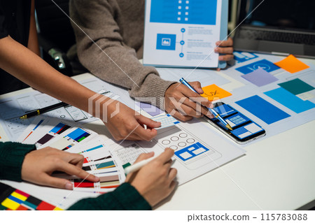 UX developer and ui designer brainstorming about mobile app interface wireframe design with customer breif and color code, User experience concept.. UX developer and ui designer brainstorming about mobile app interface wireframe design with customer breif and color code, User experience concept.. 115783088