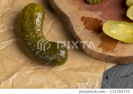 green cucumbers pickled in vinegar 115784755