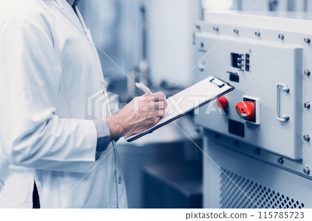 Scientist Medical Factory Staff Working in Science Lab. Medicine factory Technician Employee Check Care Products Quality in Sterilize Room Taking Note in Check list. Scientist Medical Factory Staff Working in Science Lab. Medicine factory Technician Employee Check Care Products Quality in Sterilize Room Taking Note in Check list. 115785723