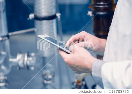 Scientist Medical Factory Staff Working in Science Lab. Medicine factory Technician Employee Check Care Products Quality in Sterilize Room with Tablet computer. Scientist Medical Factory Staff Working in Science Lab. Medicine factory Technician Employee Check Care Products Quality in Sterilize Room with Tablet computer. 115785725