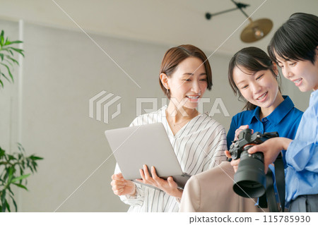 Women checking the photos they took 115785930