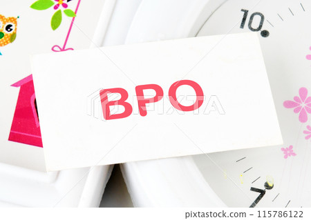 Text BPO Business Process Outsourcing text on the business card on the background of the clock 115786122