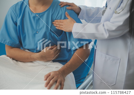 Young doctor is using a stethoscope listen to the heartbeat of the patient. Shot of a female doctor giving a male patient a check up 115786427
