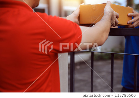 Asian delivery express courier young man use giving boxes to woman customer he wearing protective face mask at front home Asian delivery express courier young man use giving boxes to woman customer he wearing protective face mask at front home 115786506