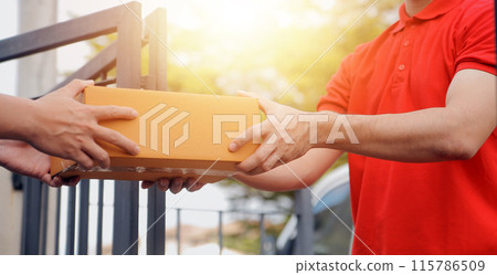 Asian delivery express courier young man use giving boxes to woman customer he wearing protective face mask at front home 115786509