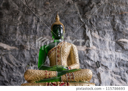 Emerald Buddha monument with gold robe in Suphan Buri cave Emerald Buddha monument with gold robe in Suphan Buri cave 115786693