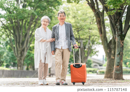 Elderly couple traveling with a suitcase (senior life, active seniors) Elderly couple traveling with a suitcase (senior life, active seniors) 115787148