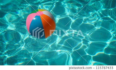 Beach ball floating in the pool 115787433