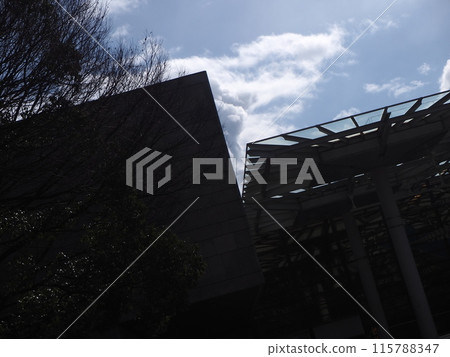 The sky seen through the gaps in the building 115788347