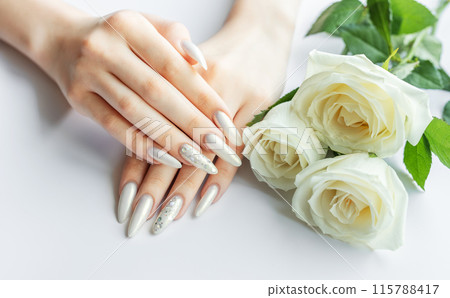 Female Hands on a white background with beautiful pearl manicure 115788417