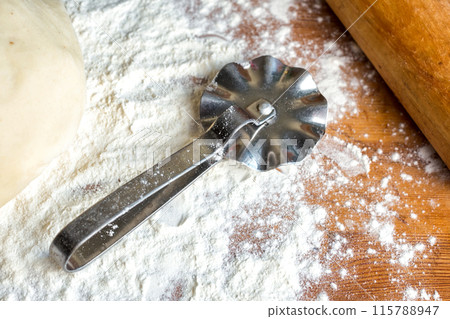 forms for squeezing the dough. dough on the table with dough tools. forms for squeezing the dough. dough on the table with dough tools. 115788947