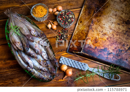 Fresh fish top view. Spicy herb and vegetables. Spice on wooden board. Healthy food cooking. 115788971