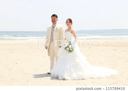 Bride in a wedding dress and groom in a tuxedo Photo wedding beach location shoot Bride in a wedding dress and groom in a tuxedo Photo wedding beach location shoot 115789410