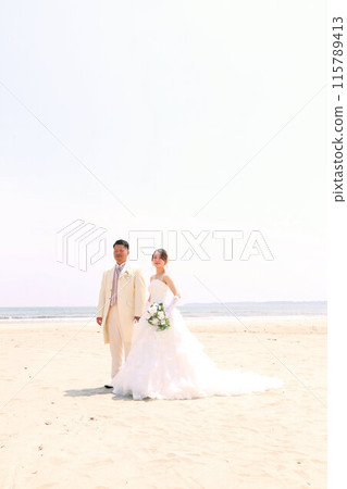 Bride in a wedding dress and groom in a tuxedo Photo wedding beach location shoot Bride in a wedding dress and groom in a tuxedo Photo wedding beach location shoot 115789413