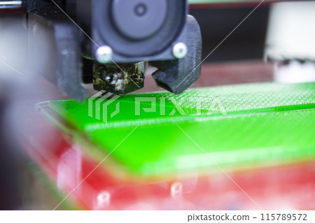 3D printer close up. Working 3D printer close-up. The process of printing on a 3D printer. 3D printer creating an object from molten plastic. 3D printer close up. Working 3D printer close-up. The process of printing on a 3D printer. 3D printer creating an object from molten plastic. 115789572