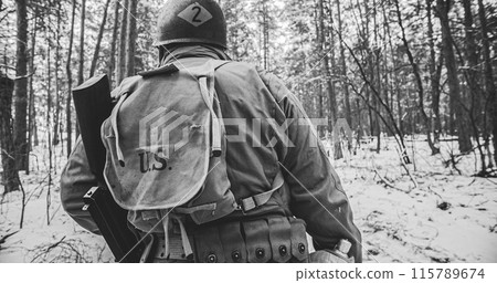 Heroes Of War. American Infantry Soldier Marching Through Forest Road In Cold Winter Day. Group Of Usa Soldiers Marching Country Road. Usa Army Soldiers Of World War Ii 115789674