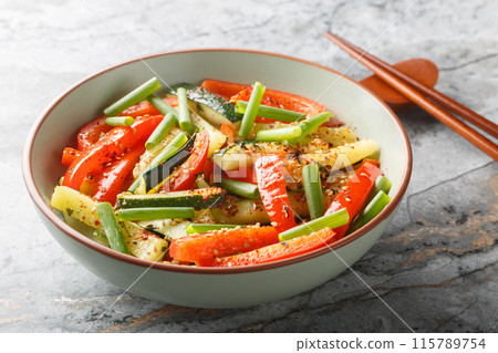 Asian style fried vegetables zucchini, green onions and bell pepper close-up in a bowl. Horizontal Asian style fried vegetables zucchini, green onions and bell pepper close-up in a bowl. Horizontal 115789754