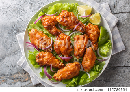 Deep Fried Tom Yam Chicken wings Thai food closeup on the plate. Horizontal top view 115789764