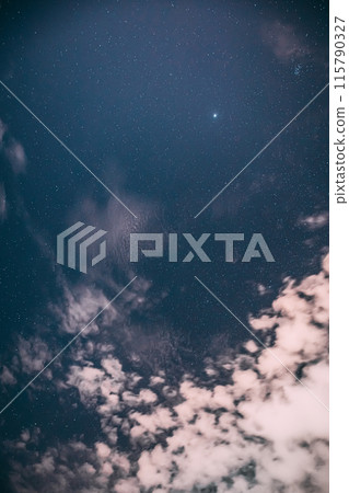 Real Night Sky Stars with some clouds cloudy sky. Natural Starry Sky Blue Color Background. unusual view natural background 115790327
