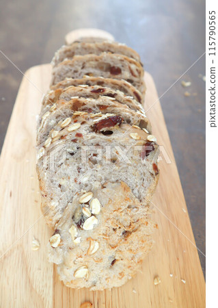 bread , whole wheat bread or sourdough bread or loaf of bread or cranberry and whole grain bread in the tray 115790565