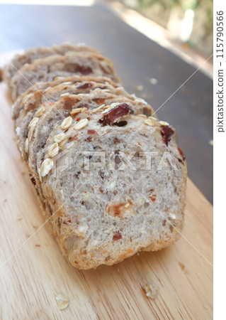bread , whole wheat bread or sourdough bread or loaf of bread or cranberry and whole grain bread in the wooden tray 115790566