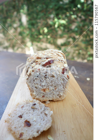 bread , whole wheat bread or sourdough bread or loaf of bread or cranberry and whole grain bread in the tray 115790567