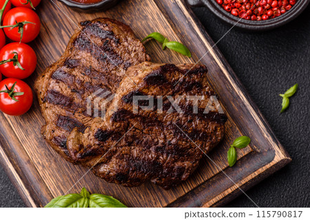 Fresh juicy delicious beef steak on a dark background 115790817