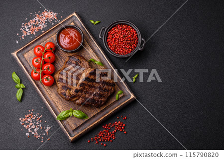 Fresh juicy delicious beef steak on a dark background 115790820