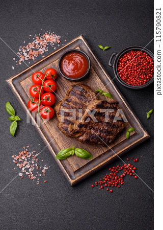 Fresh juicy delicious beef steak on a dark background 115790821