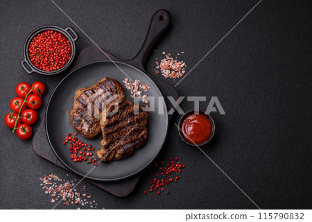 Fresh juicy delicious beef steak on a dark background 115790832