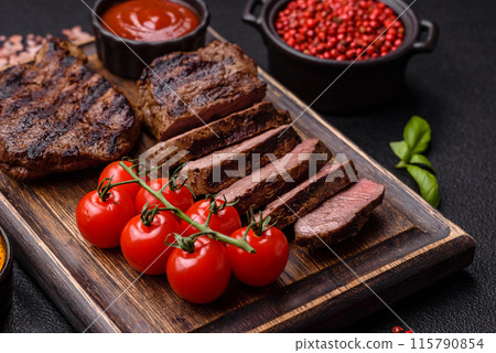 Fresh juicy delicious beef steak on a dark background 115790854