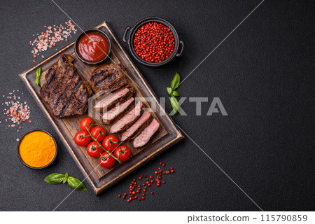 Fresh juicy delicious beef steak on a dark background 115790859