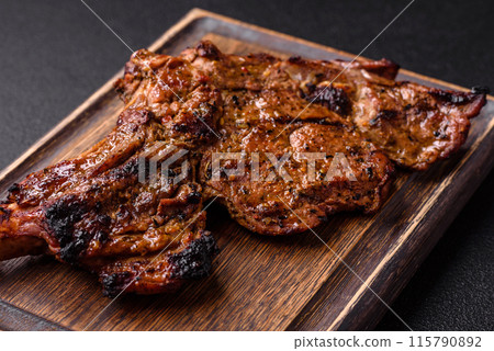 Juicy beef tomahawk steak on the bone baked on the grill Juicy beef tomahawk steak on the bone baked on the grill 115790892
