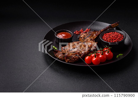 Juicy beef tomahawk steak on the bone baked on the grill 115790900