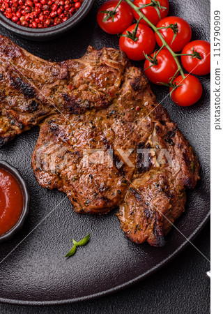 Juicy beef tomahawk steak on the bone baked on the grill Juicy beef tomahawk steak on the bone baked on the grill 115790909