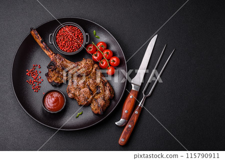 Juicy beef tomahawk steak on the bone baked on the grill 115790911